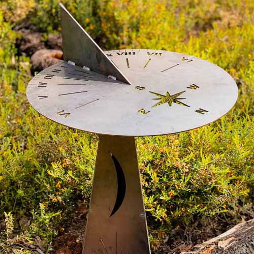 Metal Compass Sundial Functional on stand on stand in Garden Setting